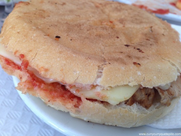 Bocadillo especial de la casa (redonet), con pan untado con tomate y especias y relleno de queso y lomo.